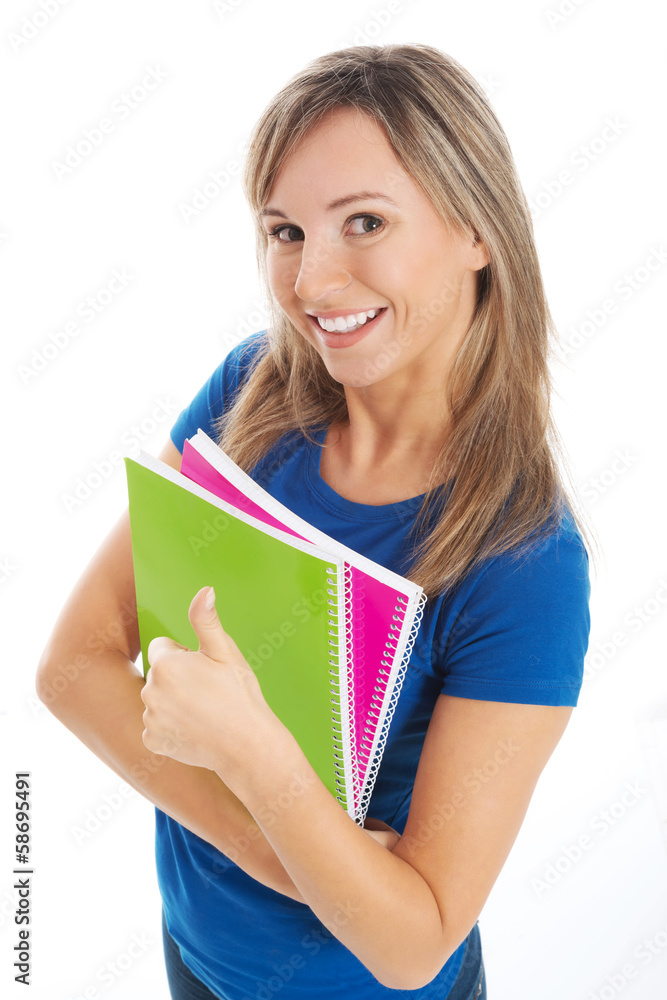 Young happy and satisfied student holding workbook. Young happy and satisfied student holding workbook.