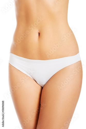 Topless woman in panties showin her flat belly. © Piotr Marcinski