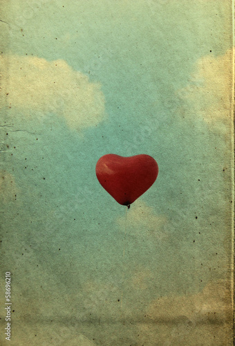 red heart balloon on the vintage textured sky