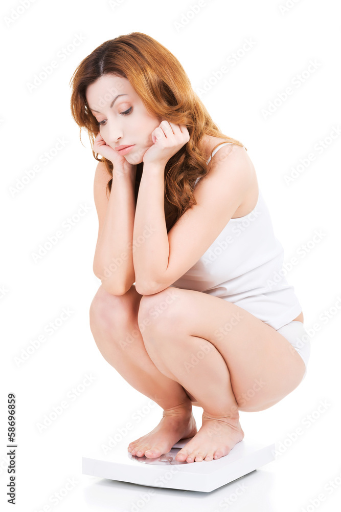 Obraz premium Sad woman on scale.