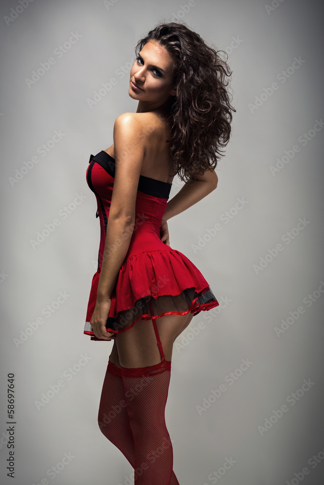 Fototapeta premium Sexy woman posing in red dress