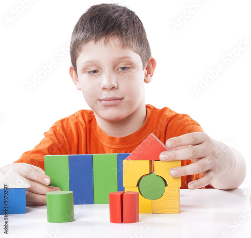 boy playing toy blocks
