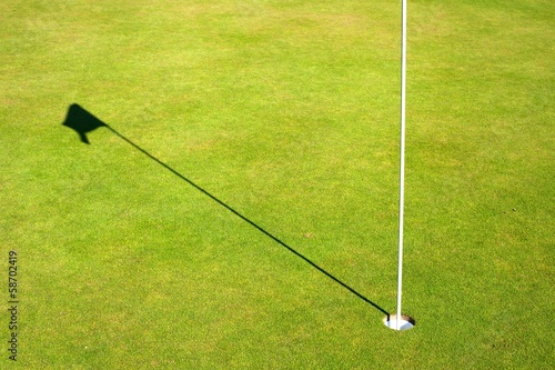 Golf course green grass background with cup