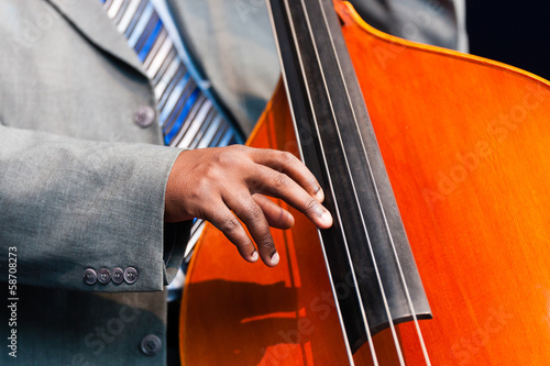 Man playing a double bass in an orchestra