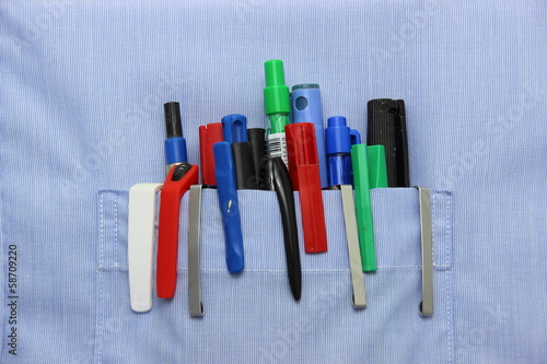 Blue shirt pocket with many different ballpoint pen