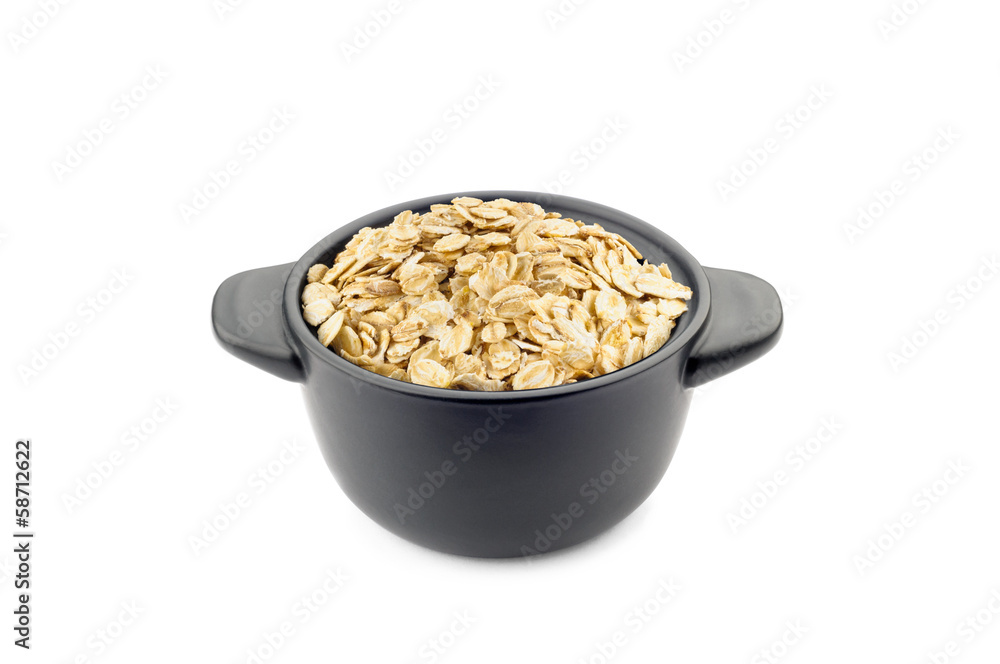 Oat flakes in a little black ceramic dish Oat flakes in a little black ceramic dish