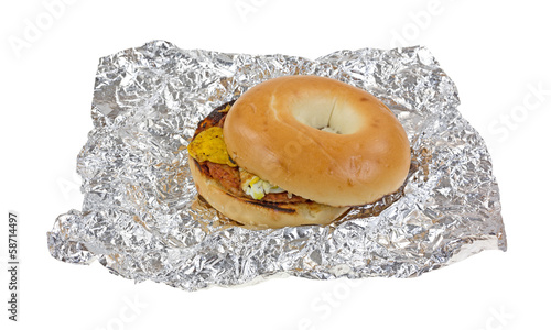 Unwrapped breakfast bagel sandwich on tinfoil