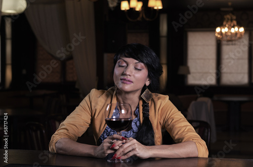 Young woman savouring a glass of red wine