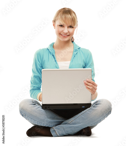 A woman with a laptop and headset sitting on the floor