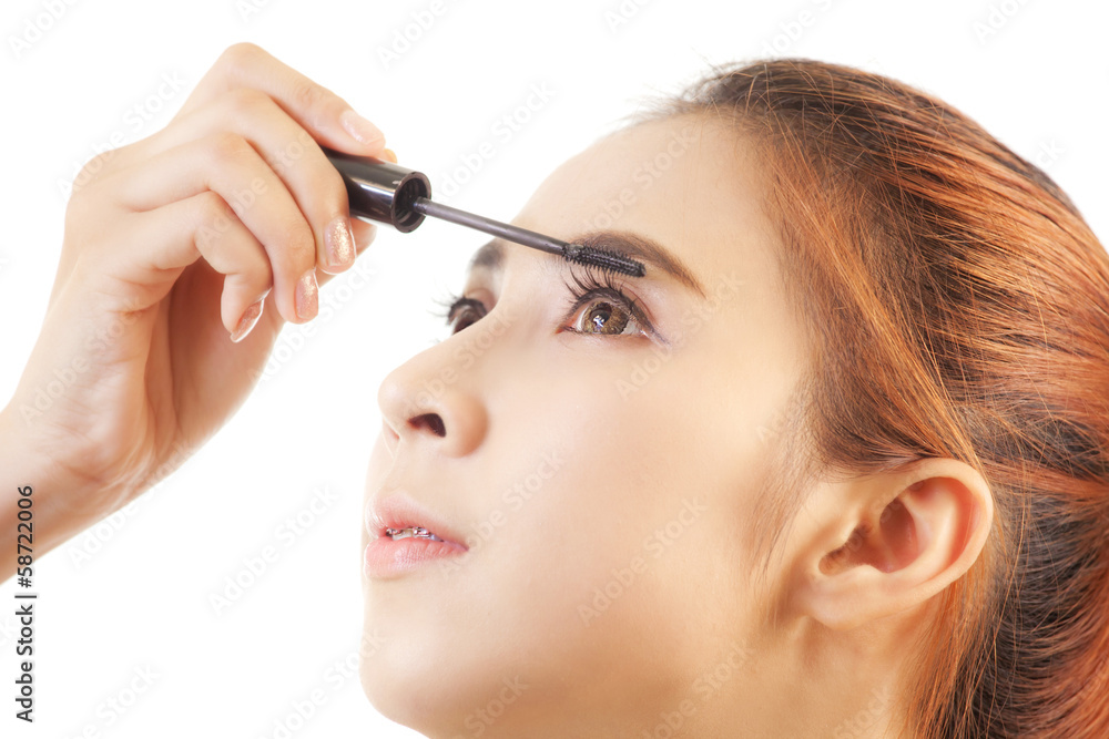 Woman applying mascara Woman applying mascara