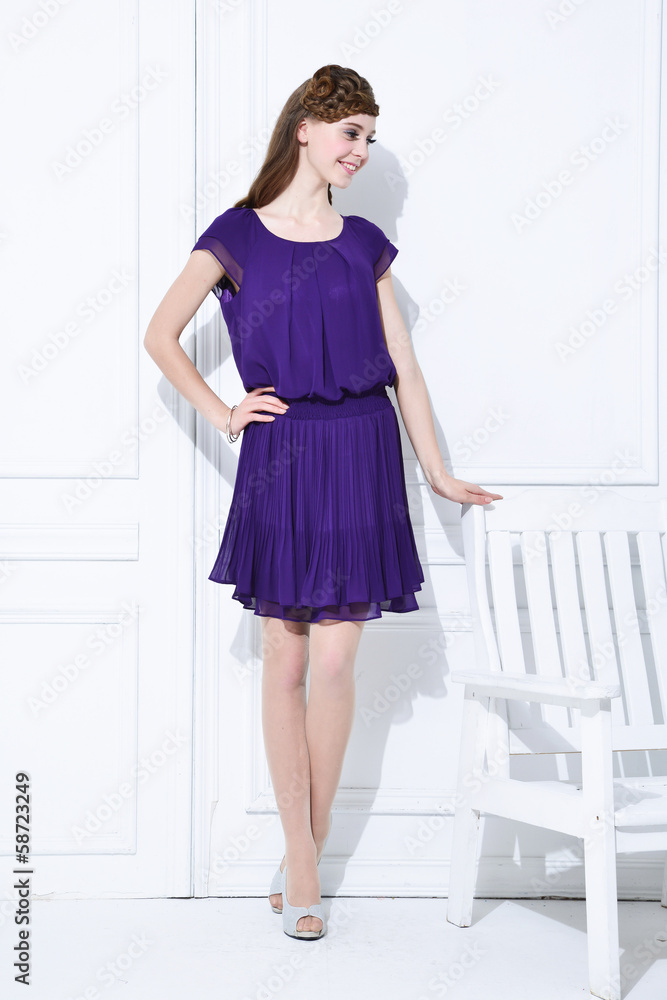 professional model in near wooden chair posing