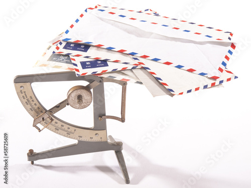 antique postage scale with airmail letters with white background photo