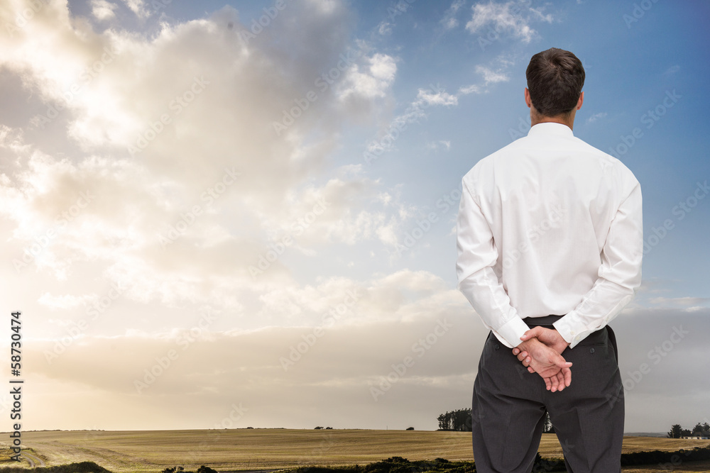 Composite image of businessman turning his back to camera