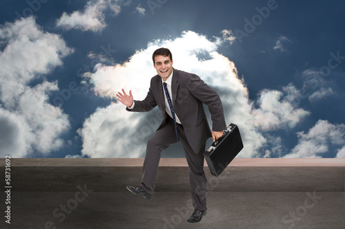 Composite image of cheerful businessman in a hury photo