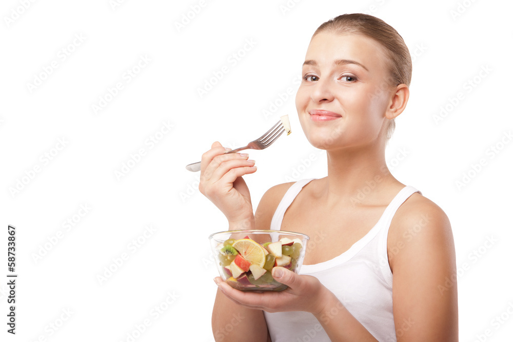 Pretty girl eating fruit salad isolated Pretty girl eating fruit salad isolated