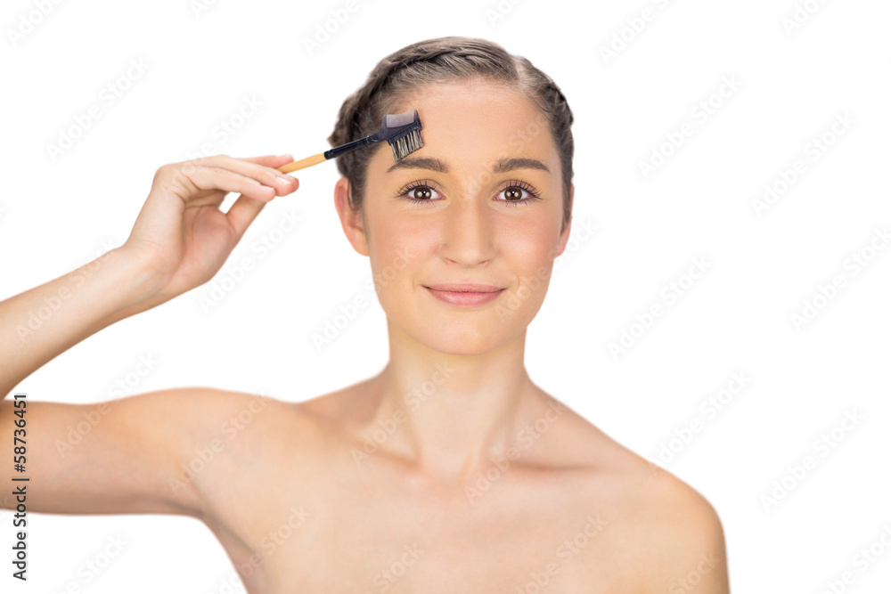 Smiling gorgeous model using eyebrow brush Smiling gorgeous model using eyebrow brush
