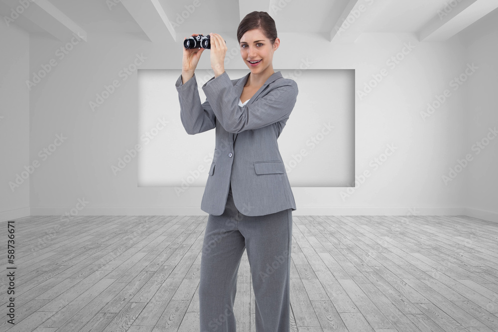 Composite image of businesswoman posing with binoculars Composite image of businesswoman posing with binoculars