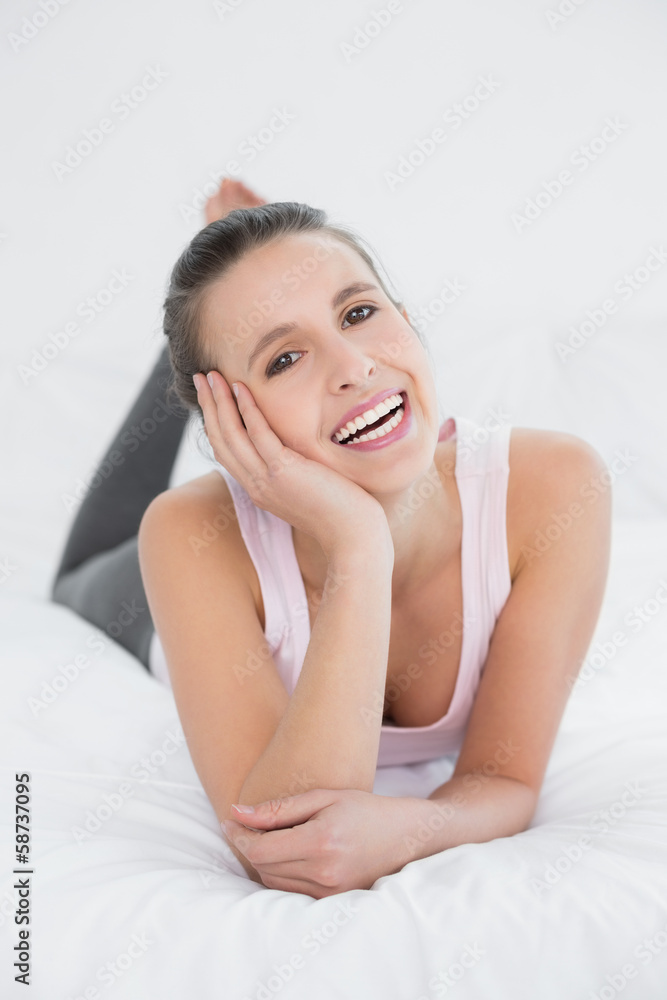 Cheerful pretty young woman relaxing in bed Cheerful pretty young woman relaxing in bed