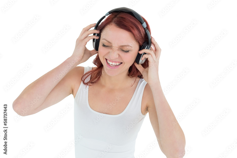 Casual woman enjoying music through headphones Casual woman enjoying music through headphones