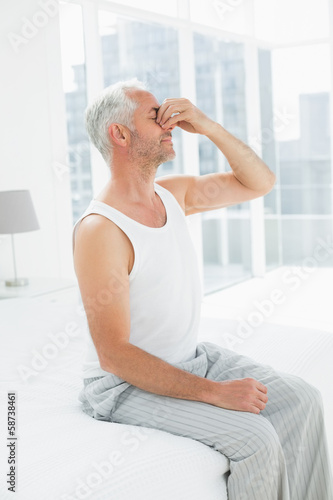 Side view of a thoughtful mature man in bed