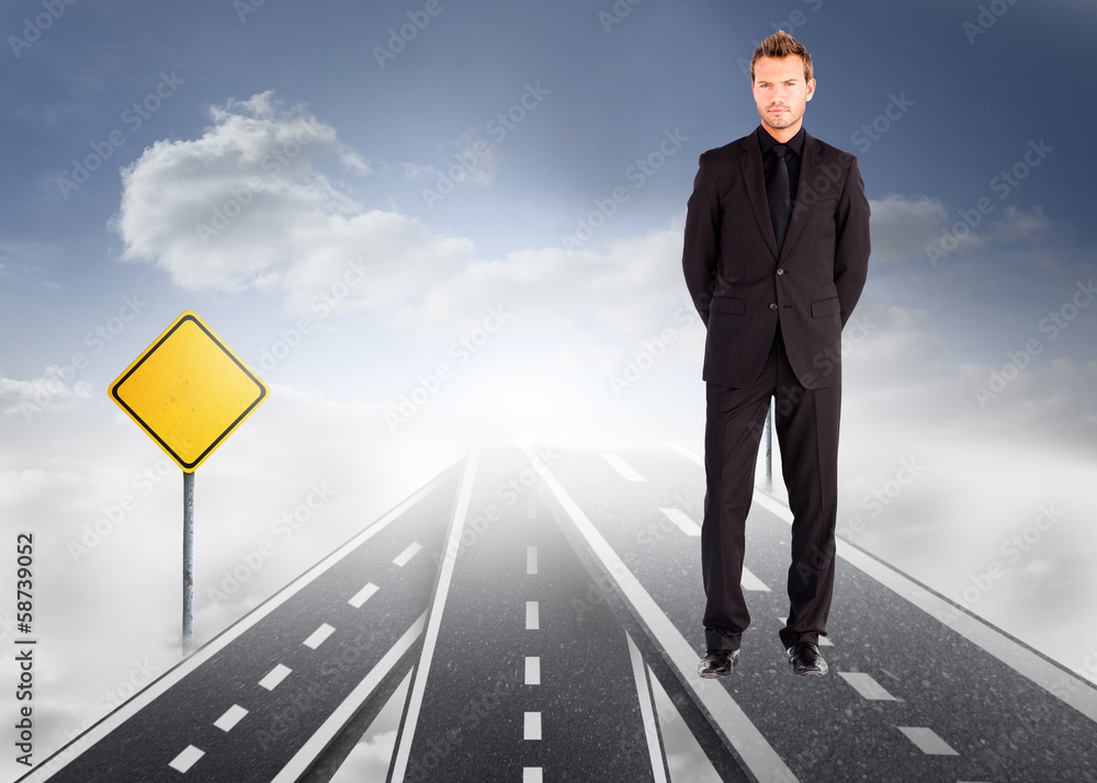 Composite image of young businessman looking at the camera Composite image of young businessman looking at the camera