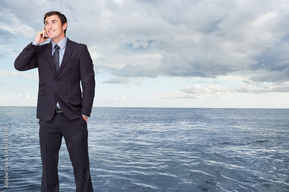 Composite image of happy businessman phoning Composite image of happy businessman phoning