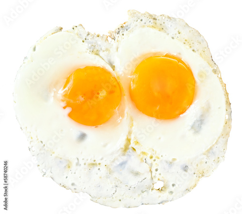 top view of two fry eggs on white