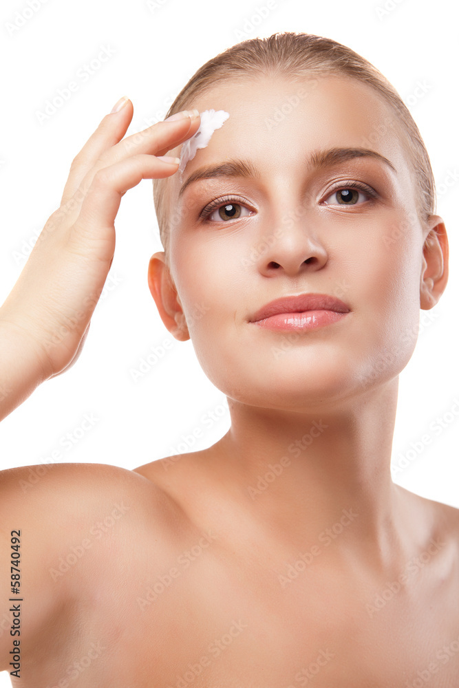 Woman applying moisturizer cream on face isolated Woman applying moisturizer cream on face isolated