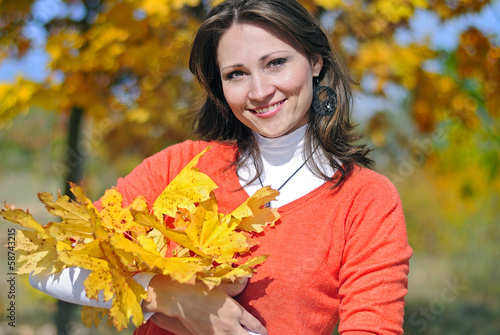 portrait of a beautiful girl among the yellow leaves in autumn
