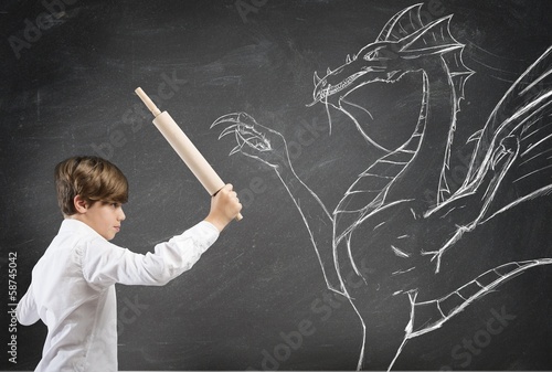 Brave boy fighting a dragon