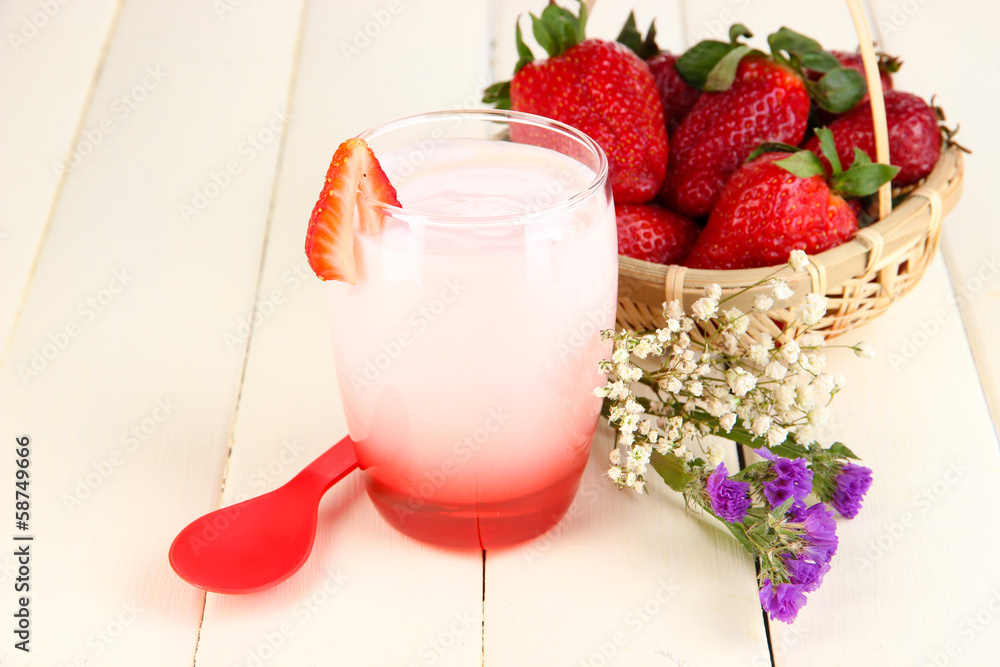 Delicious strawberry yogurt in glass on wooden table close-up Delicious strawberry yogurt in glass on wooden table close-up