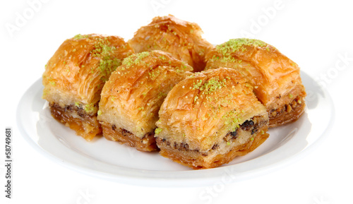 Foto Sweet baklava on plate isolated on white