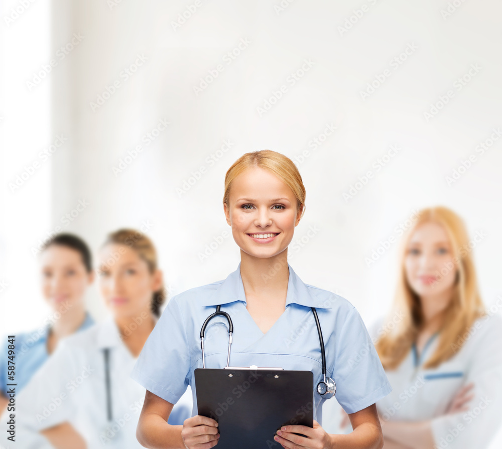 smiling female doctor or nurse with clipboard smiling female doctor or nurse with clipboard
