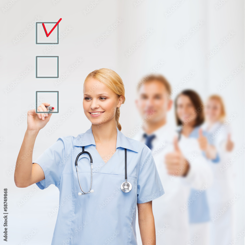 © Syda Productions - doctor or nurse drawing checkmark into checkbox
