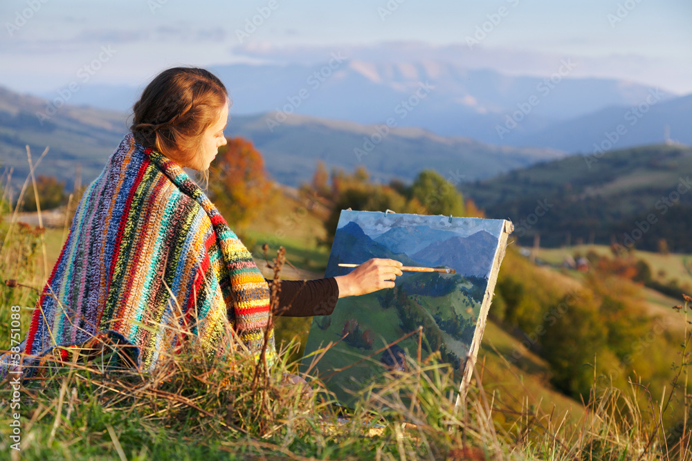 Fototapeta premium Young artist painting an autumn landscape