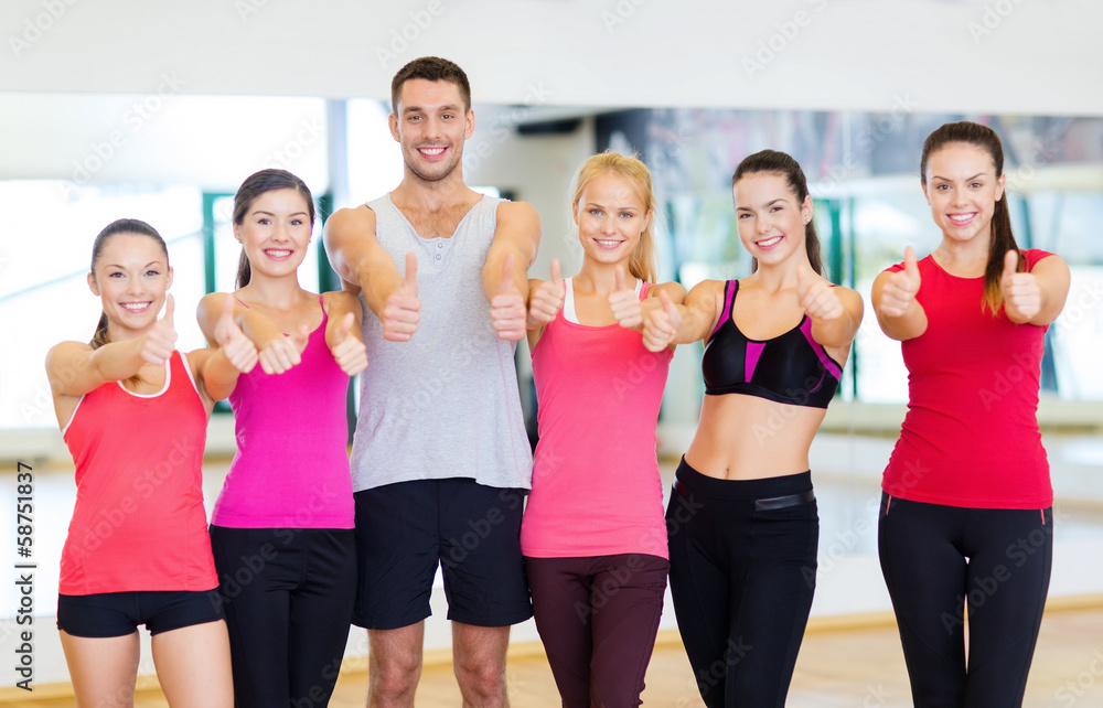 group of people in the gym showing thumbs up group of people in the gym showing thumbs up