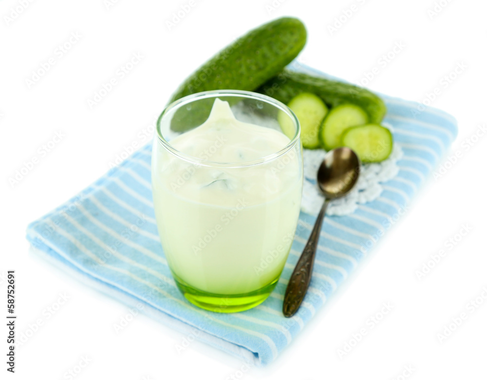 Cucumber yogurt in glass, on color napkin, isolated on white Cucumber yogurt in glass, on color napkin, isolated on white