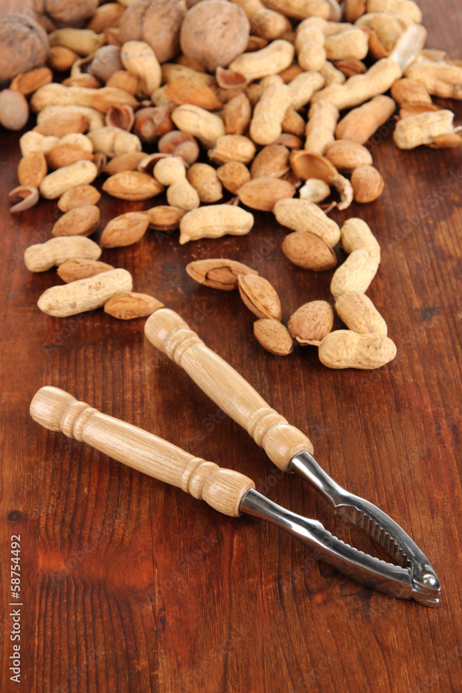 Nutcracker with nuts on wooden table close-up Nutcracker with nuts on wooden table close-up