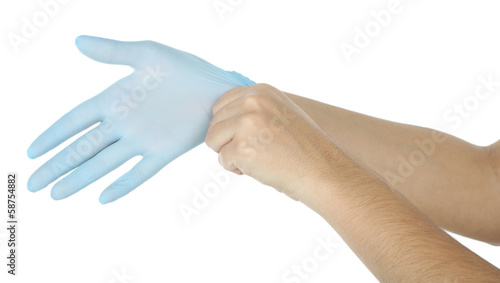 Doctor putting on protective gloves, isolated on white © Africa Studio