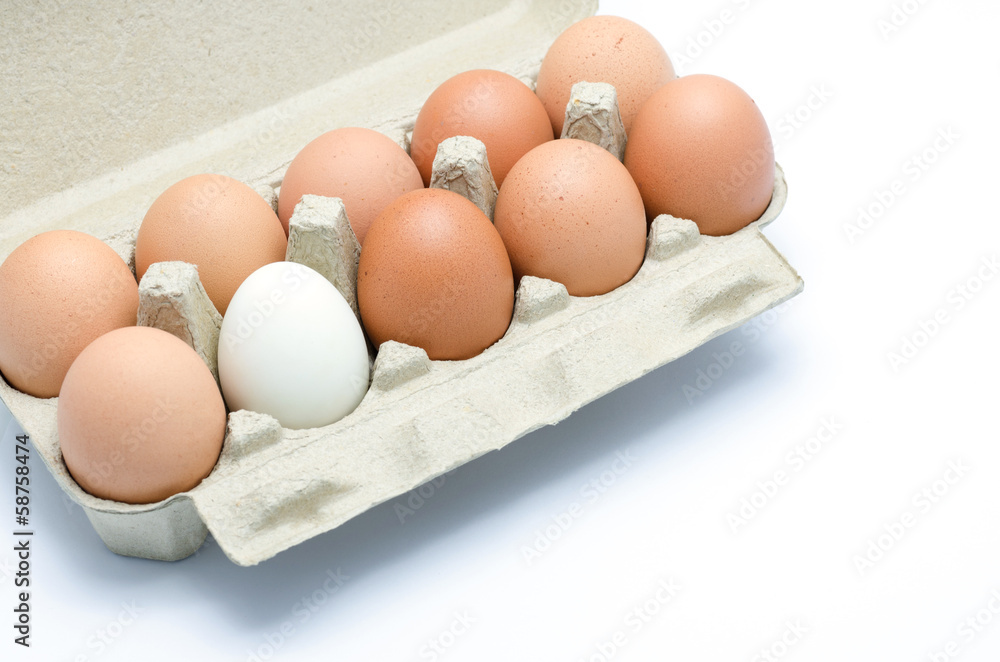 white and brown eggs in a carton package