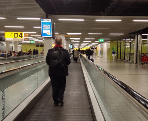 Traveller on a moving walkway in an airport
