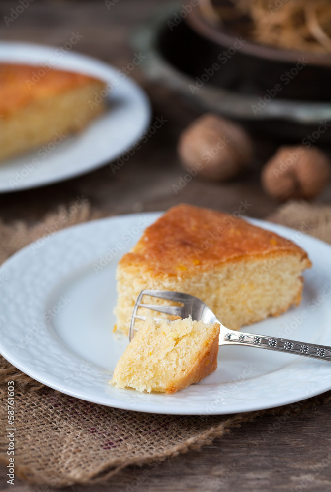 A piece of traditional Greek yoghurt cake Yaourtopita with orang A piece of traditional Greek yoghurt cake Yaourtopita with orang