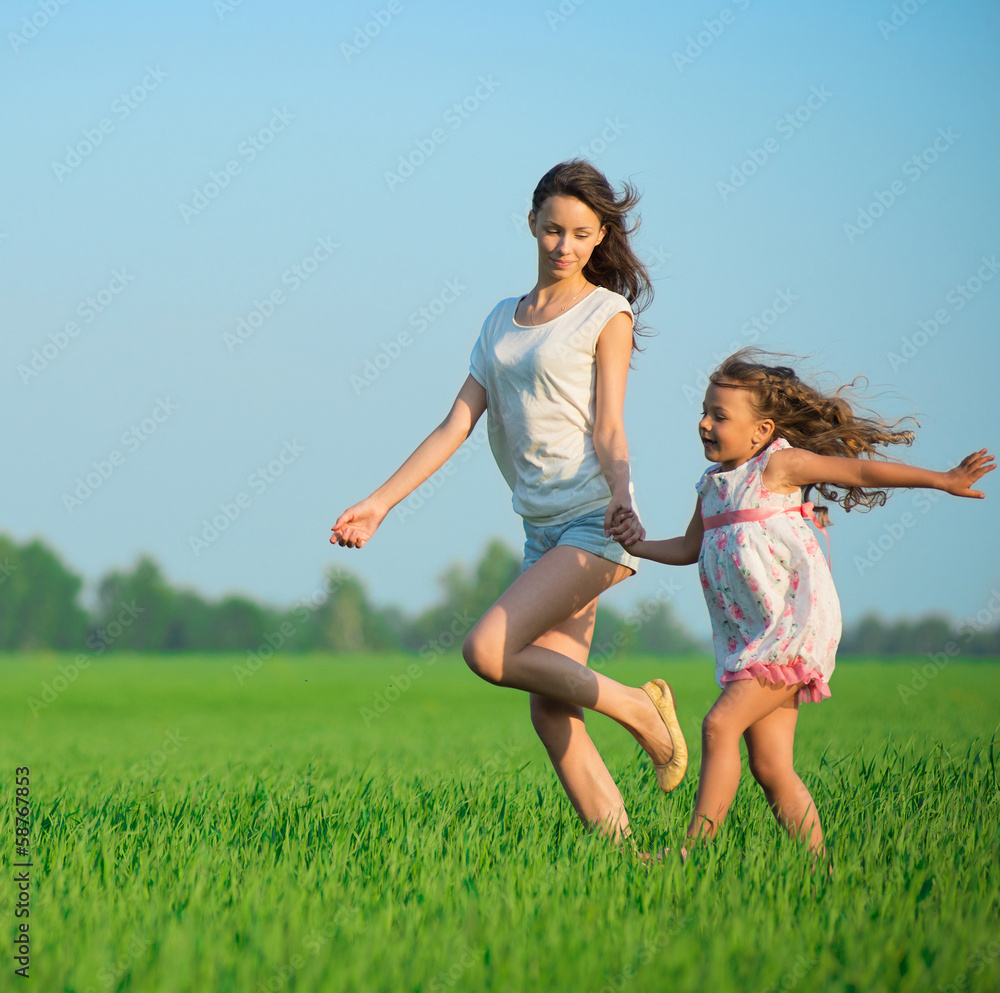 Young happy girls running at green wheat field Young happy girls running at green wheat field
