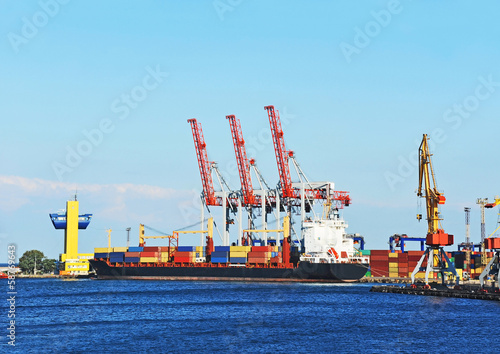 Container stack and ship under crane bridge