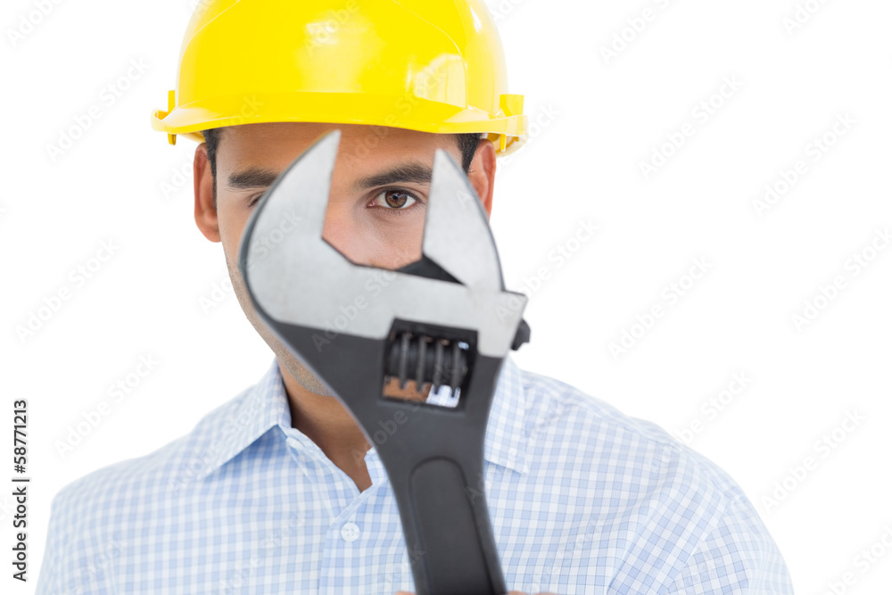 Close-up portrait of a young handyman with a wrench Close-up portrait of a young handyman with a wrench
