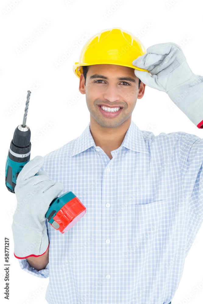 Smiling handsome young handyman in hard had with drill Smiling handsome young handyman in hard had with drill