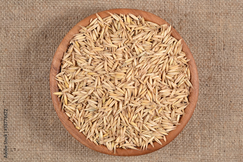 Oat seeds in a wooden bowl