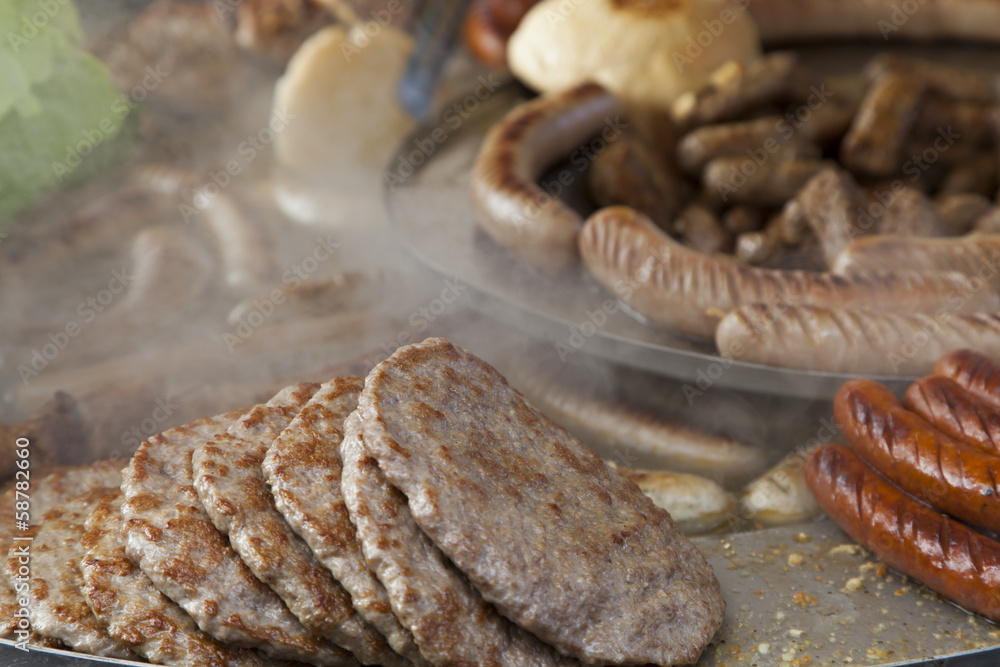 Delicious Balkan cevapi, meat rolls on BBQ