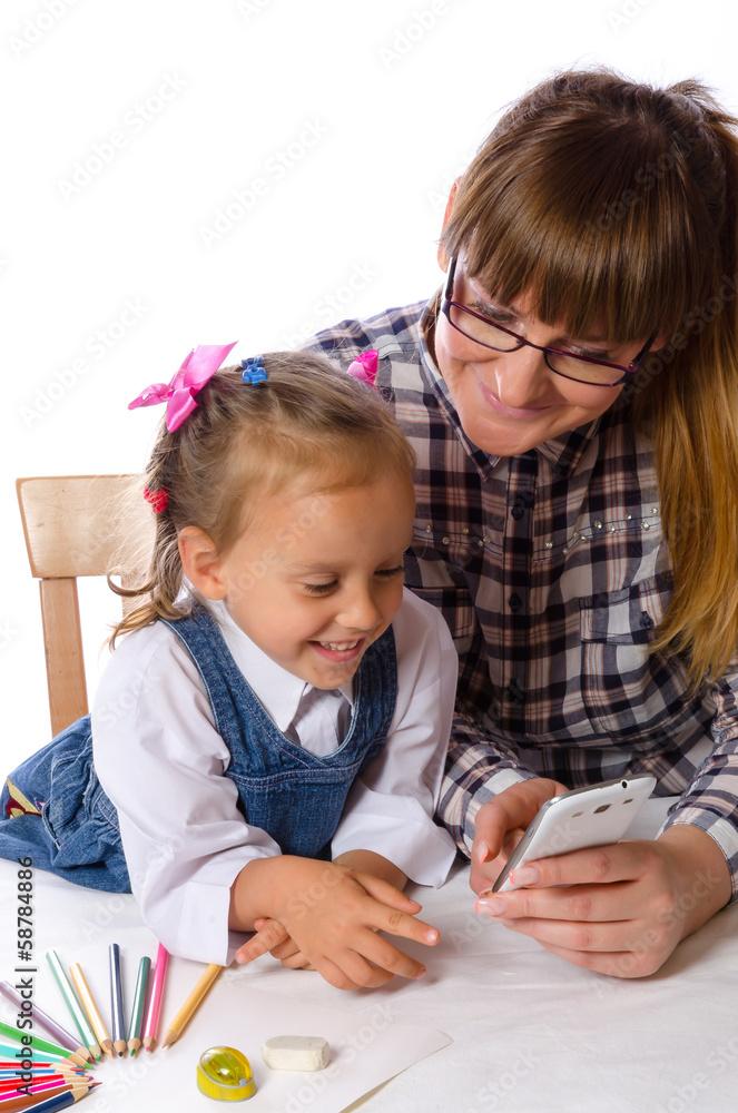 mother and daughter with mobile phone mother and daughter with mobile phone
