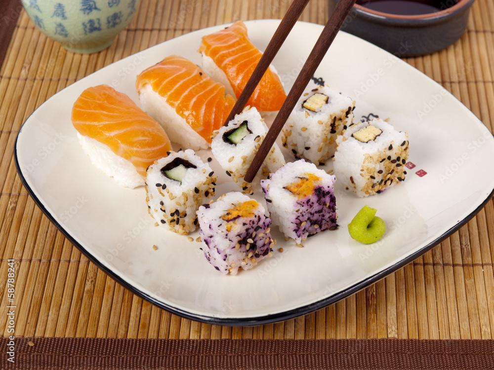 Fresh sushi and sashimi on a plate with chopsticks and soy sauce Fresh sushi and sashimi on a plate with chopsticks and soy sauce
